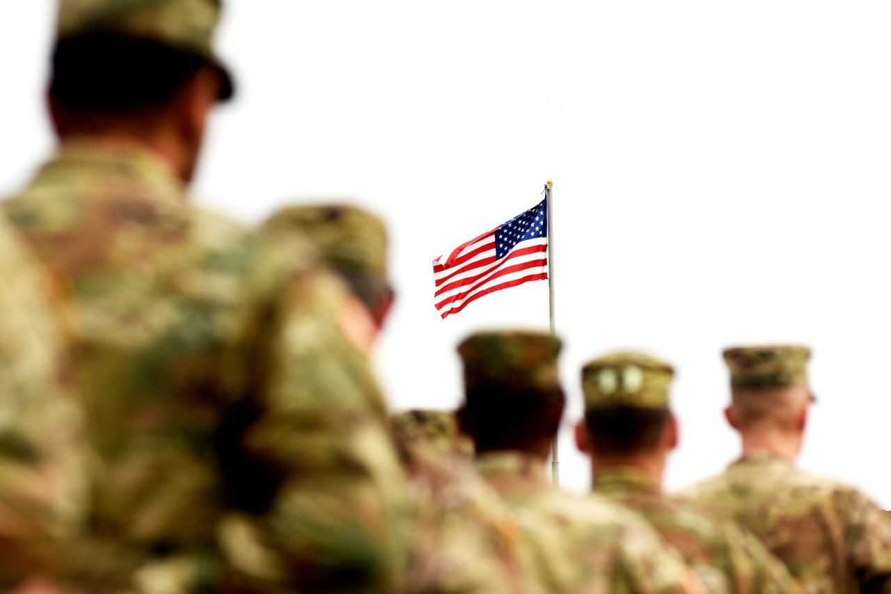 Soldiers saluting the American Flag