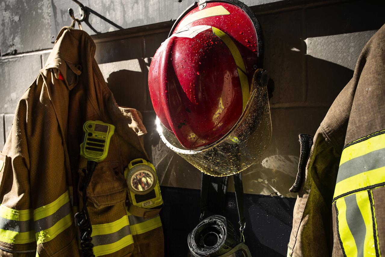 Image of firefighter clothing hanging on wall